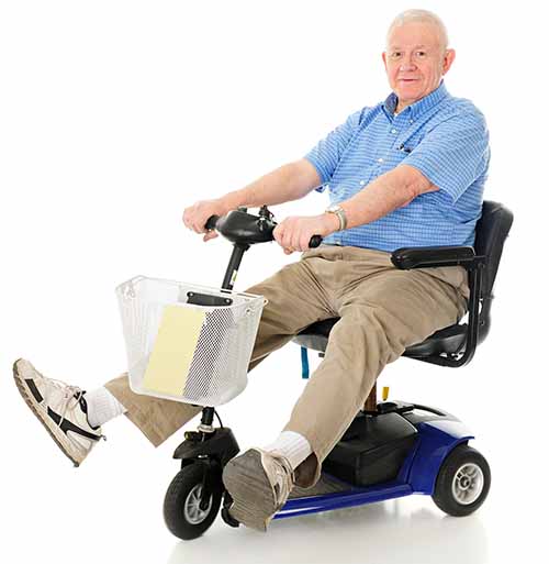 A senior man enjoys driving his mobility scooter