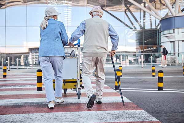 Elderly couple on the airport with a cane